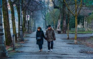 Older couple walking together on a foothills trail on a clear fall day