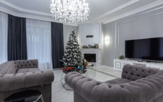 Cozy living room with a blanket on the couch and snow visible through the window